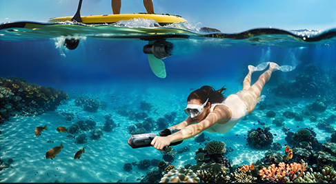 AI-assisted scene of a swimmer using a scooter beneath a paddleboard, with tropical fish and coral